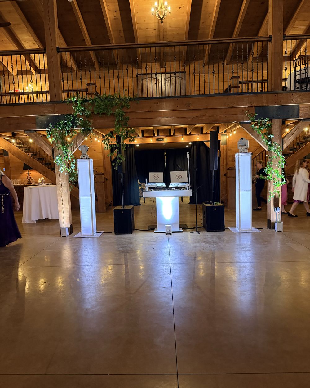 DJ Steven Share's booth and lit totems in the main hall at Colloca Estate Winery, with the balcony above
