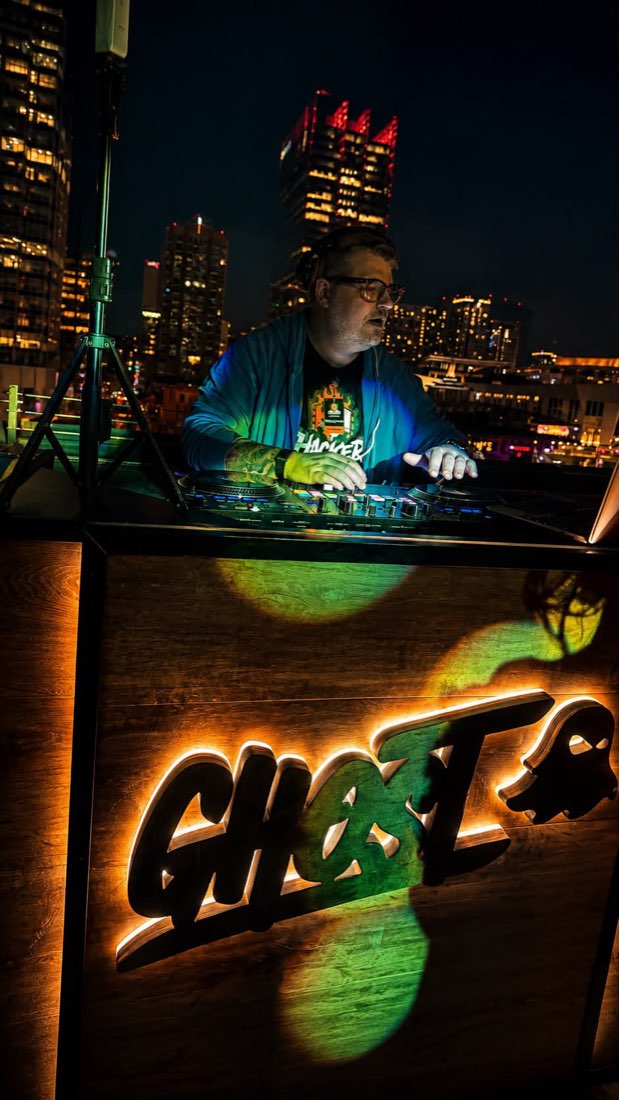 Steven Share performing on the rooftop at Ole Red, with the Nashville skyline behind the booth
